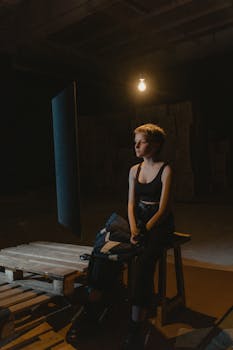 Woman in Black Tank Top Sitting on Chair